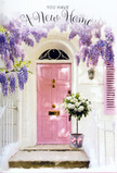 Here, a welcoming Cowley front step is captured at the precise moment when flowers and architecture come together to celebrate a move into a new home. A soft, dusky pink front door stands proudly at the centre, its pastel shade warm and inviting against the surrounding whitewashed wall. To one side, a coordinating pink shutter helps frame the doorway and adds an easy, village-like charm that feels at home among Cowley's residential streets and little side alleys. Above, a generous cascade of wisteria drapes over the doorway, spilling lavender-tinged blossoms in loose, trailing clusters. The vine's tangled stems and leaves mingle with the hanging flowers, forming a natural arch that casts speckled shadows across the pink door and the step below. Sitting squarely on the threshold is a grey metal bucket, chosen as a rustic container for a lush bouquet of white and cream roses. The roses are fully open, their broad, layered petals giving the arrangement a plush, almost cushion-like appearance, while soft green foliage threads through the blooms to introduce contrast and depth. Around the bucket, a blush-pink ribbon is tied neatly, its bow soft and slightly relaxed, echoing the same gentle tones found in the door and shutter. The subtle afternoon light makes the roses seem to glow, while the cool grey of the bucket and the pale stone of the step ground the scene. Altogether, the image conveys a mood of calm excitement and tender optimism, perfectly suited for congratulating friends or family settling into a new address in Cowley, with flowers on the doorstep offering a quiet promise of comfort, joy, and fresh beginnings.